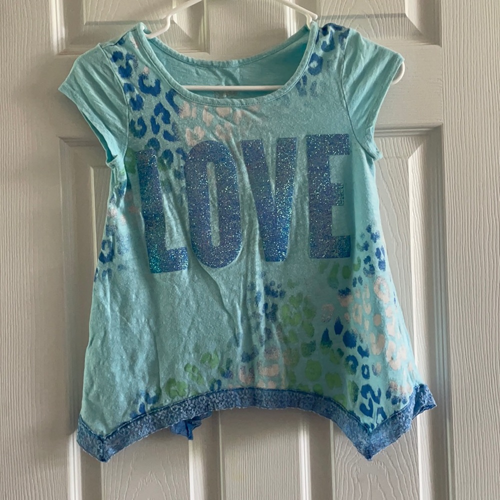 Cute sharkbite glittered Justice graphic tee.